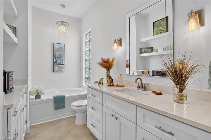 Custom double-sided Bathroom with vanities, sinks, soaking tub and walk in shower.