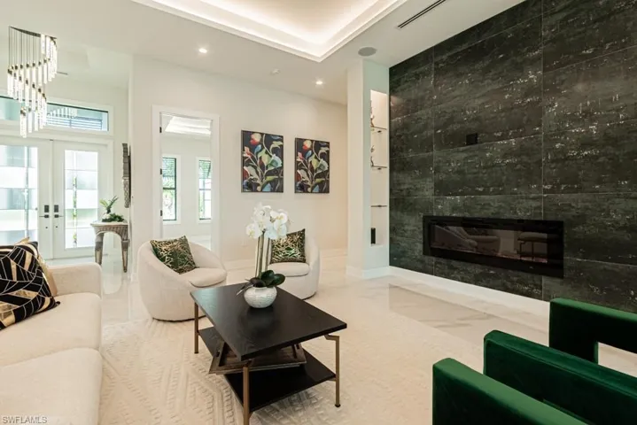 Living room with french doors and a tiled fireplace