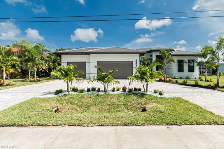 View of front facade with a garage and a front lawn