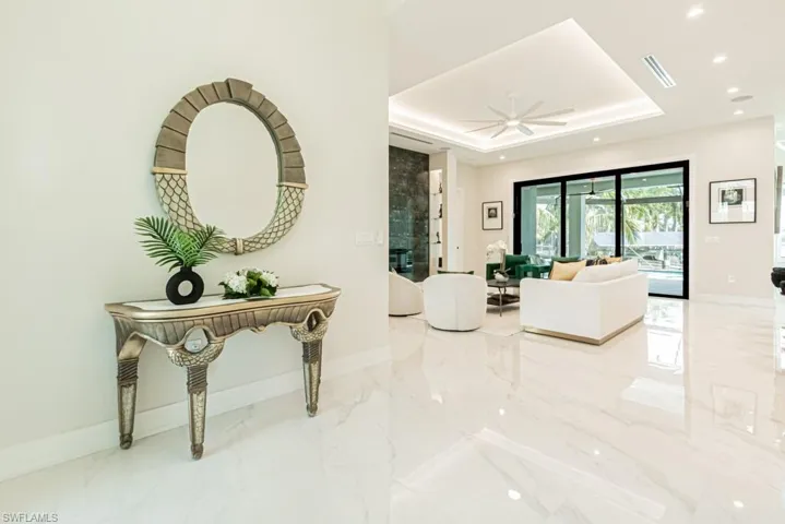 Corridor featuring a tray ceiling