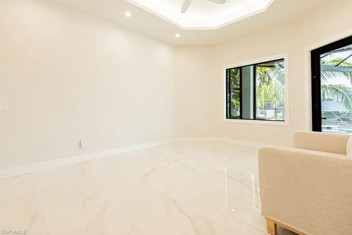 Spare room with ceiling fan and a raised ceiling