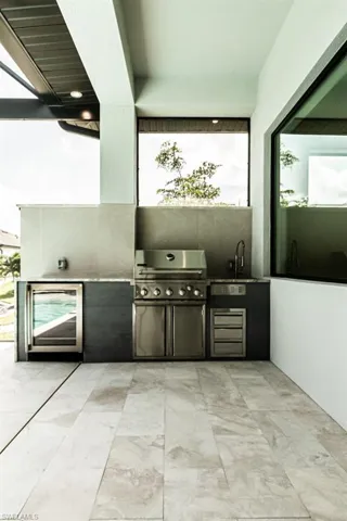 View of patio with an outdoor kitchen, area for grilling, and sink