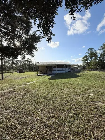 Rear property view with mature trees.