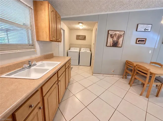 Kitchen with ample cabinetry and adjacent dining area.