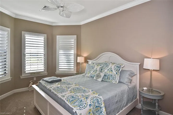 What an inviting and spacious Guest Room with Plantation Shutters