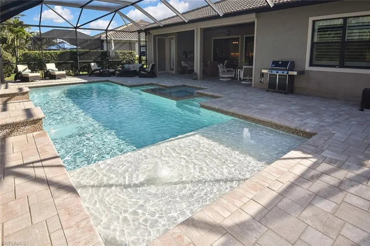The "beach area of the pool with bubblers