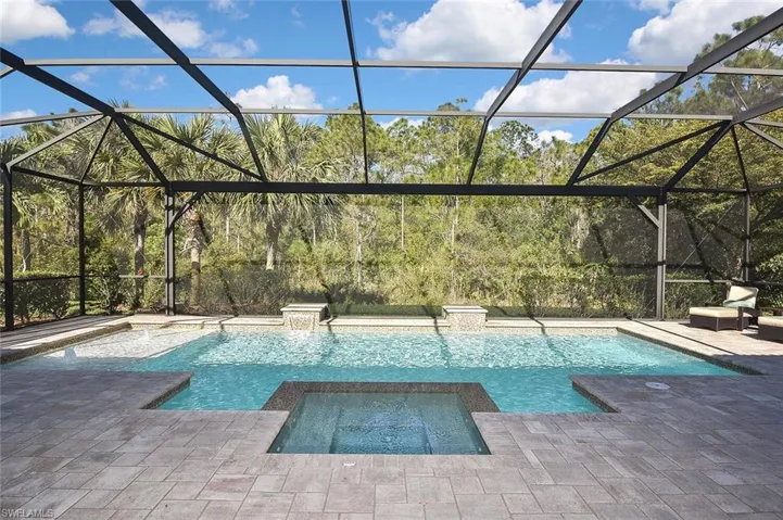 The Custom Pool with Bubblers, Water Falls and Spa overlooking the Preserve through expansive picture frame screening for an unobstructed view.