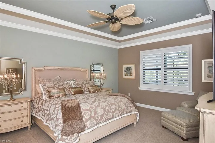 The Primary Retreat, with sitting area, Plantation shutters and a view of Pool, Spa, Lanai, and Preserve