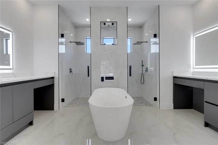 Full bathroom with vanity, walk in Shower and a freestanding tub