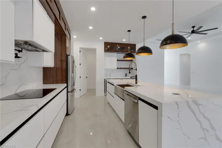 Kitchen featuring modern cabinets, pot filler and design details perfect for a master chef