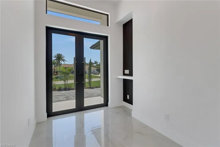 Entryway with french doors and marble finish floor