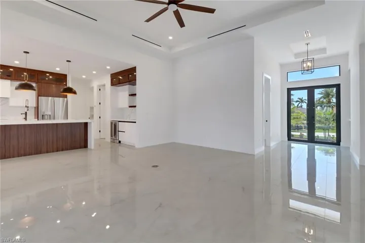 living room featuring marble finish floor and vaulted ceiling