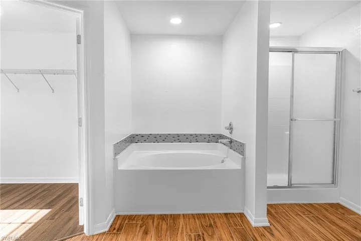 Deep soaking tub with decorative tile surround and chrome fixtures