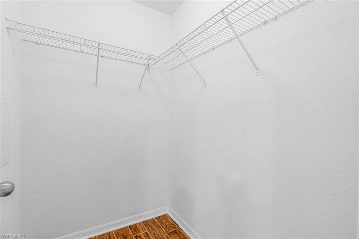 Corner closet featuring white wire shelving