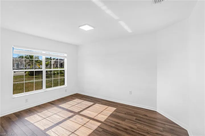 Bright interior space featuring a large window with white blinds