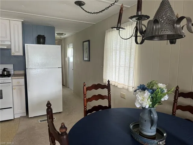 Dining area featuring light colored carpet