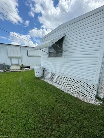View of home's exterior with a yard