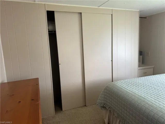 Bedroom with light carpet
