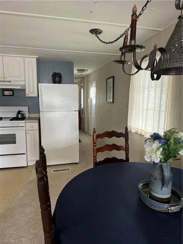 Carpeted dining room featuring plenty of natural light