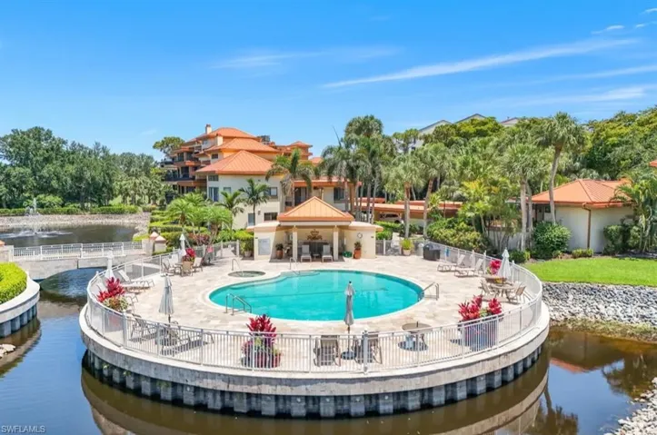 Community pool with a water view and a patio