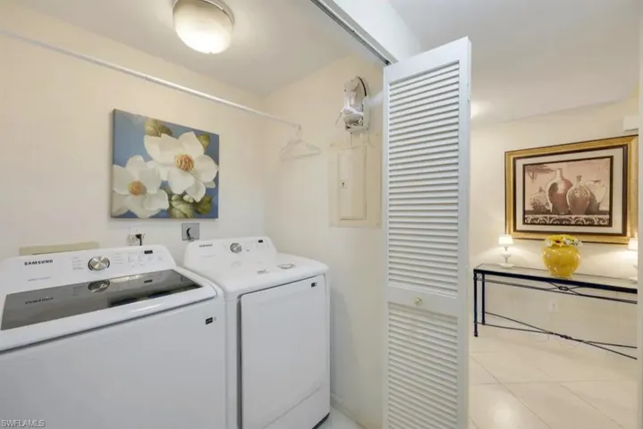 Washroom with washing machine and dryer and electric panel