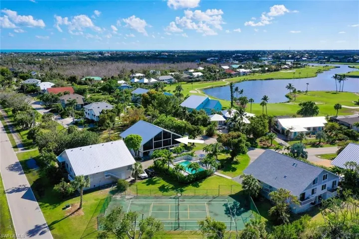 Aerial view of residential area featuring a nearby body of water