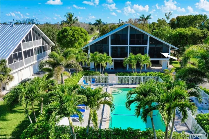 Community pool with a sunroom and a patio area