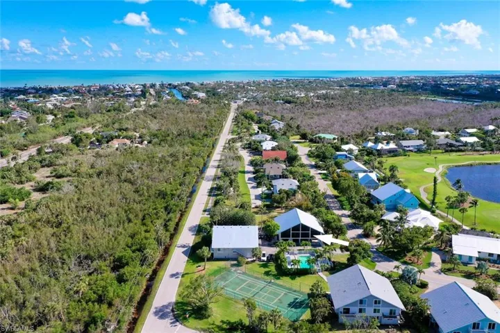 Aerial perspective of suburban area with a large body of water and a local golf course