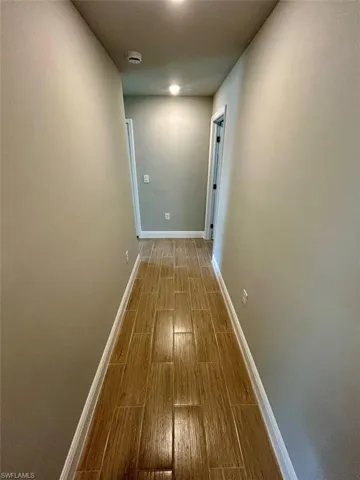 Corridor with wood tiled floors and a textured ceiling