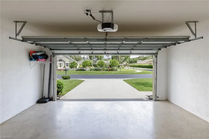 Garage featuring a textured wall and a garage door opener