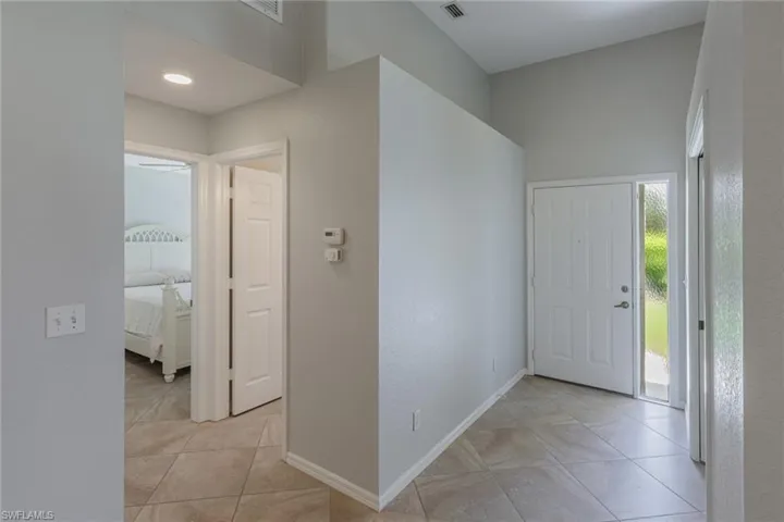 Foyer featuring a textured wall and light tile patterned floors
