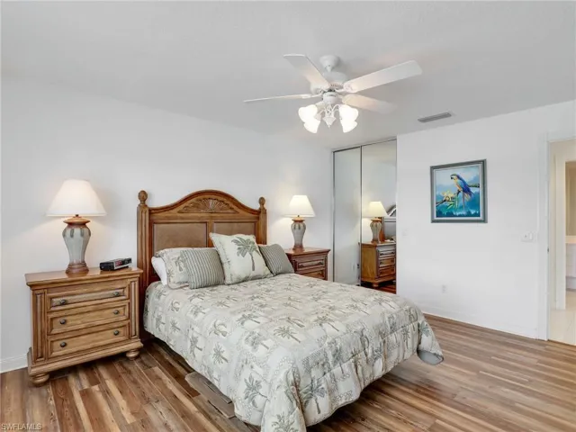 Bedroom featuring ceiling fan, a closet, and wood-type flooring