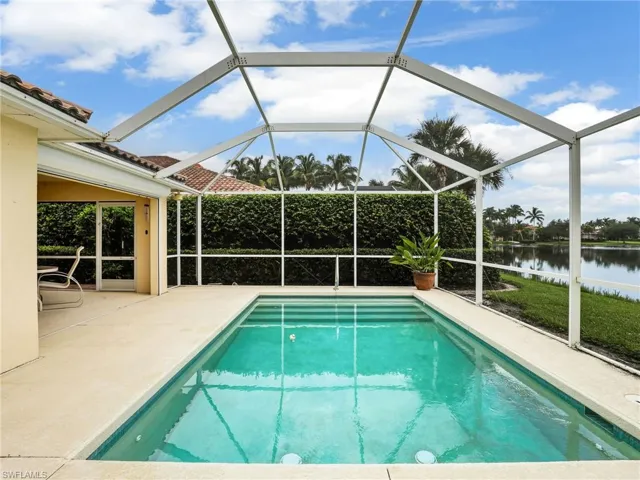 View of pool featuring a patio, a lanai, and a water view