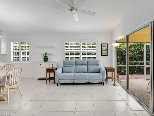 Tiled living room featuring ceiling fan