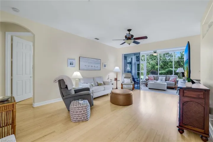 Living room featuring ceiling fan and light hardwood / wood-style flooring