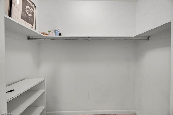 Large walk in closet located in hallway