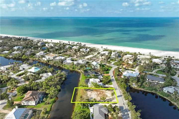 Aerial perspective of suburban area featuring unending shoreline and property parcel outlined