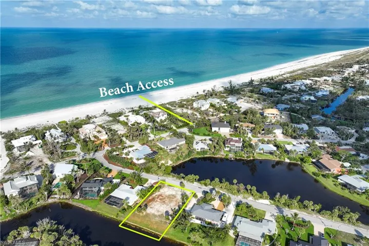 Aerial view of residential area with expansive coastline and property parcel outlined