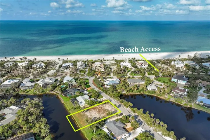 Aerial view of residential area featuring unending shoreline and property boundaries highlighted