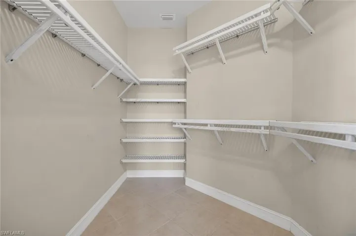 Walk in closet featuring light tile patterned flooring