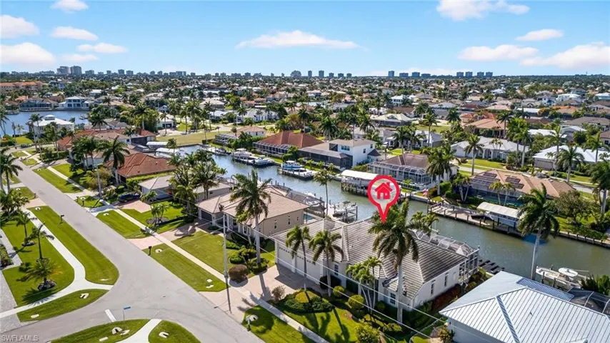 Aerial view of residential area with skyline and a nearby body of water