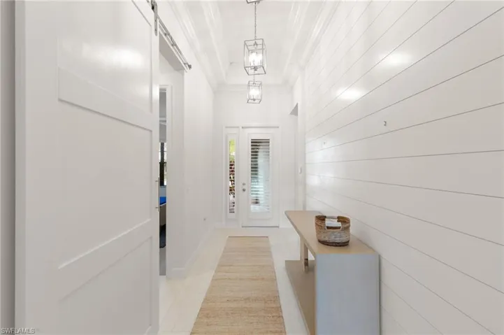Laundry area featuring light tile patterned flooring, cabinet space, and washer and clothes dryer