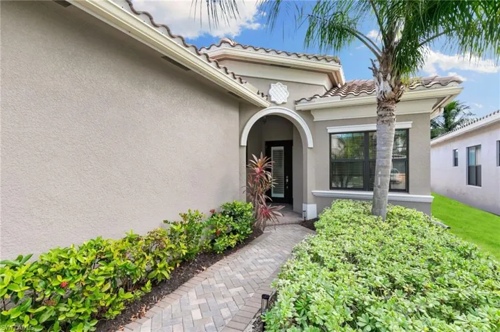 Entrance to property with stucco siding and a tile roof