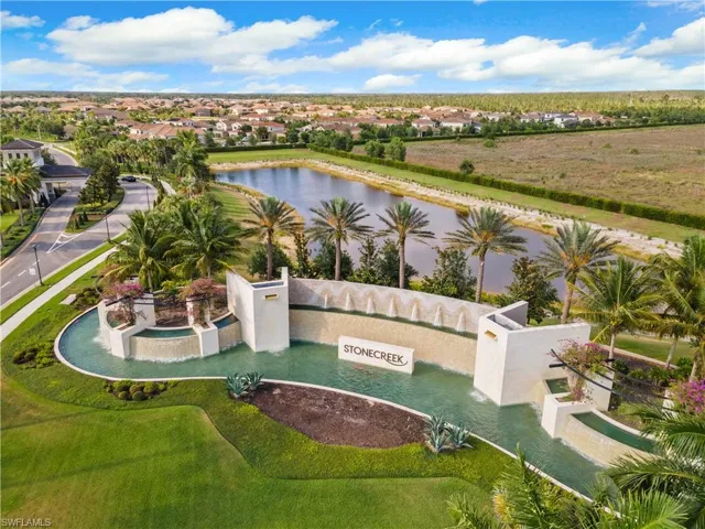 Aerial view of residential area with a pool and a nearby body of water