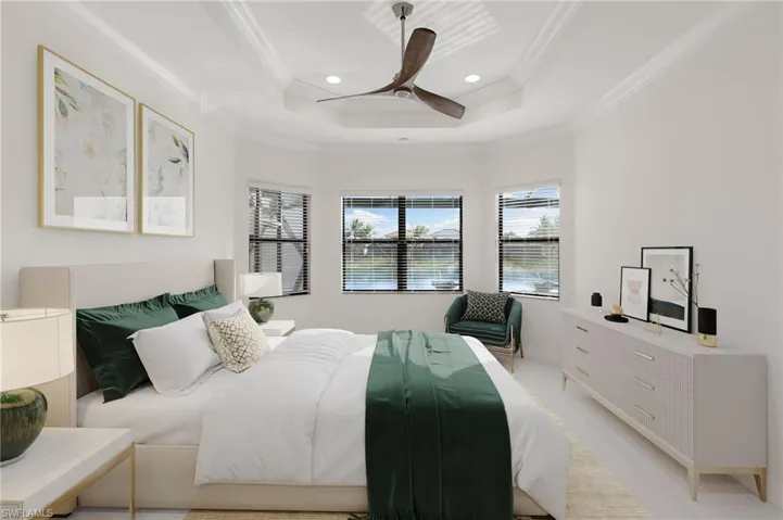 Bedroom featuring a raised ceiling, ornamental molding, ceiling fan, and recessed lighting