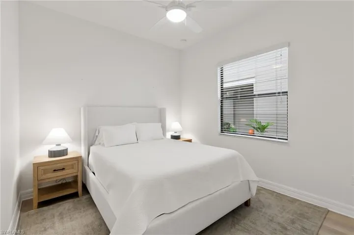 Bedroom with a ceiling fan and light wood finished floors
