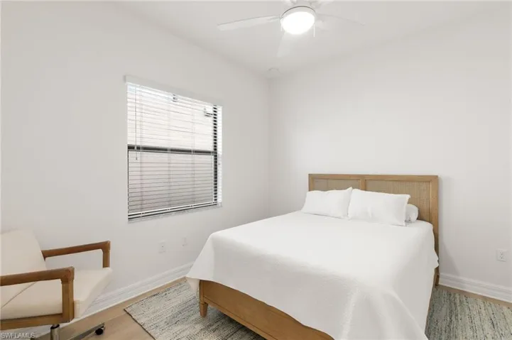Bedroom with a ceiling fan and wood finished floors