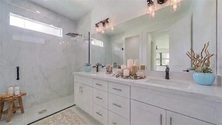 Dual vanity/sinks with a gorgeous all tile walk-in rain shower! (Virtually staged)
