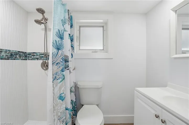 Full bathroom featuring a shower stall and vanity - Virtually Edited Image