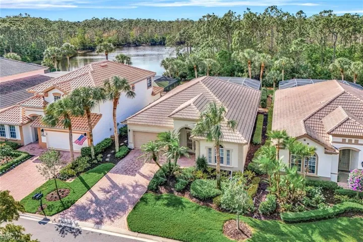 Bird's eye view with a water view and a wooded view